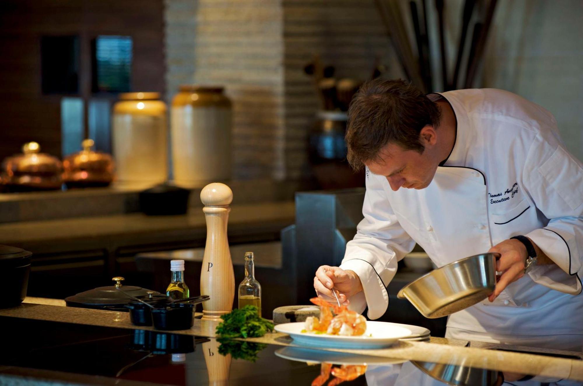 Hyatt Regency Chennai Hotel Exterior photo A chef seasoning a dish